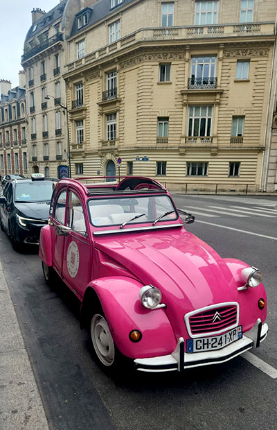 Touring in a pink Citroen car in Paris
